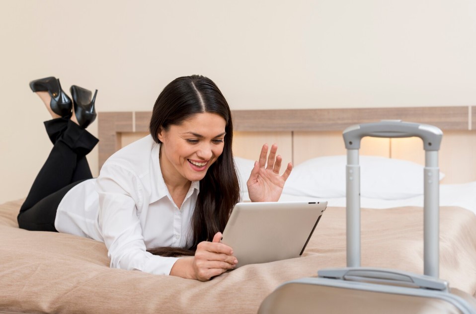 Woman using tablet in hotel room