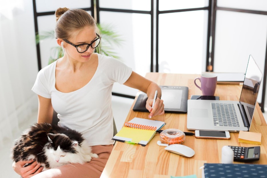Front view of woman holding cat