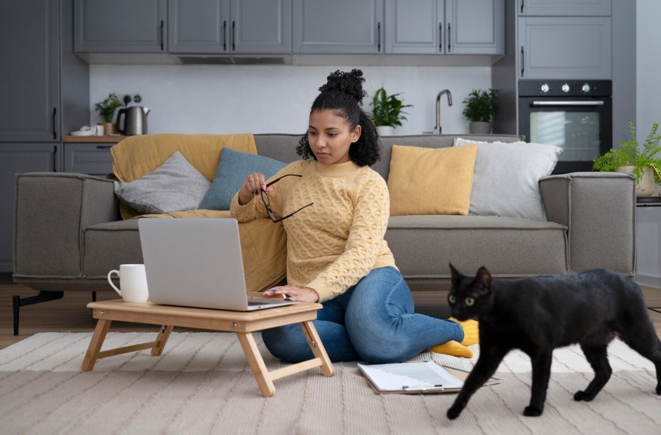  woman sitting on floor with pet black cat