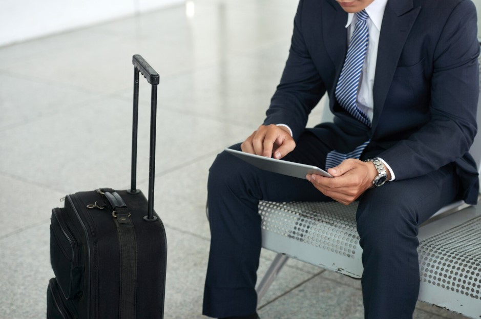  Businessman using tablet computer in airport