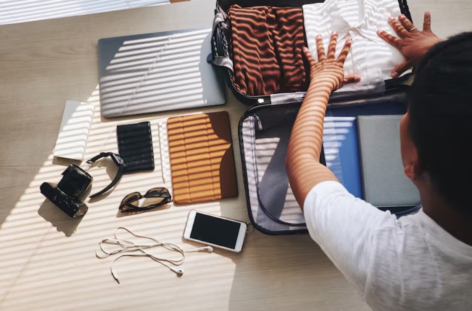 man packing suitcase for trip