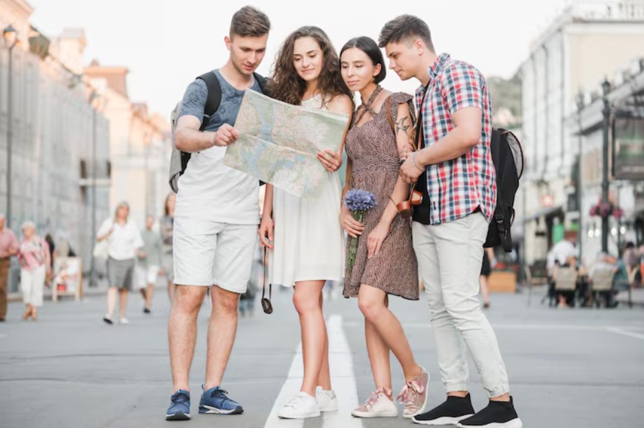 Young people standing on street discovering city map