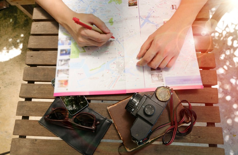 person writing in map