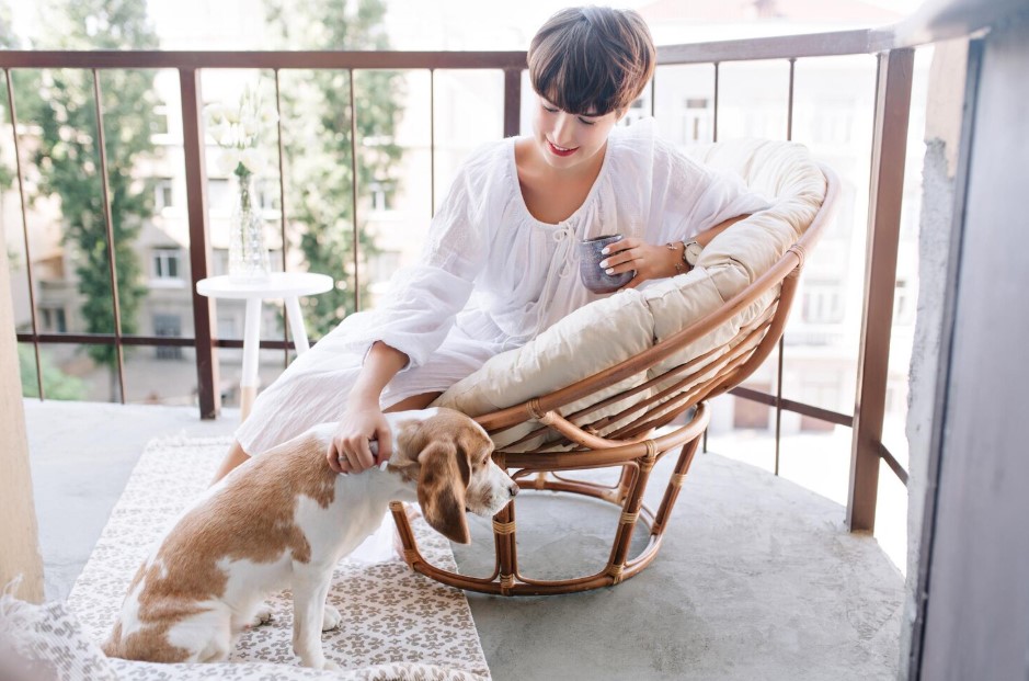 girl with coffee and pet dog in the balcony