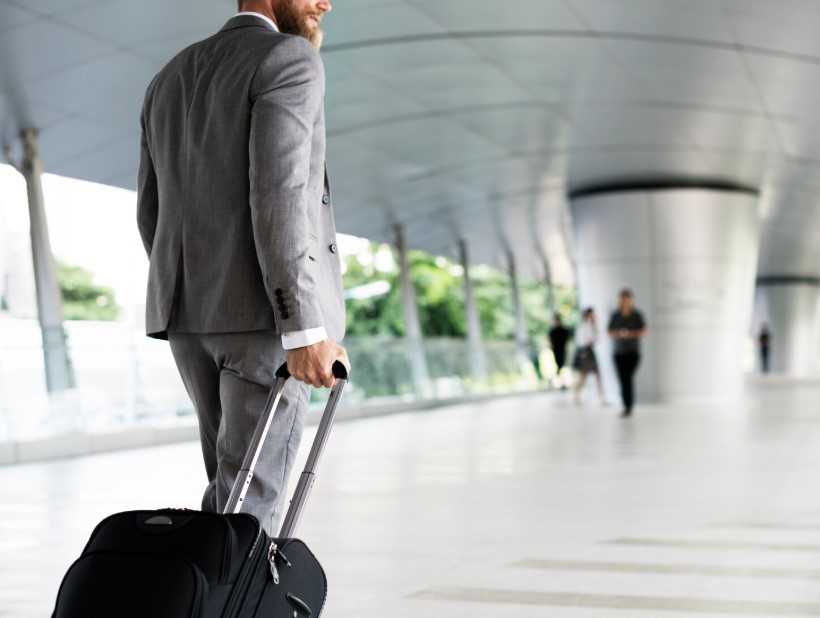 Businessman holding luggage for business trip