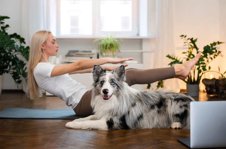 Person doing yoga accompanied by her pet
