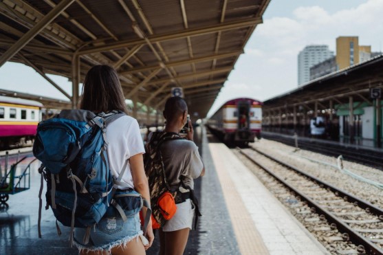 two backpackers waiting for train