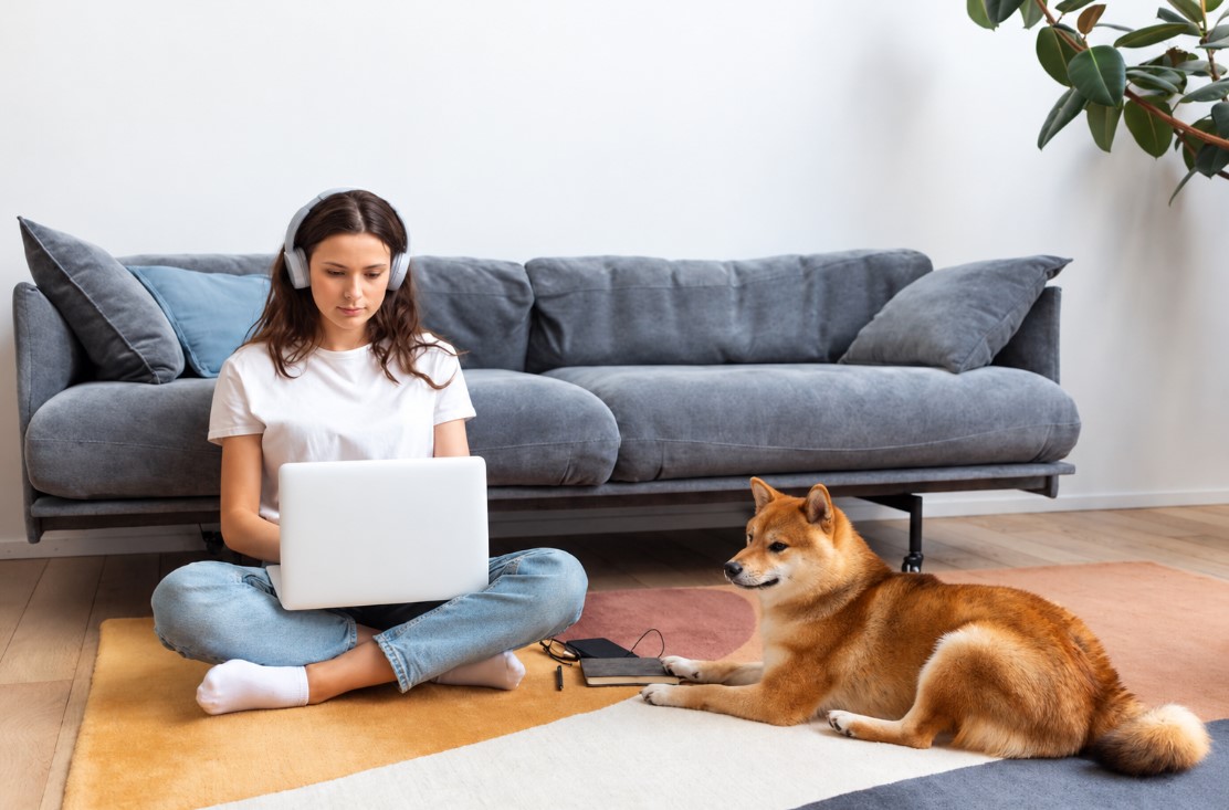 Woman trying to work with her dog around