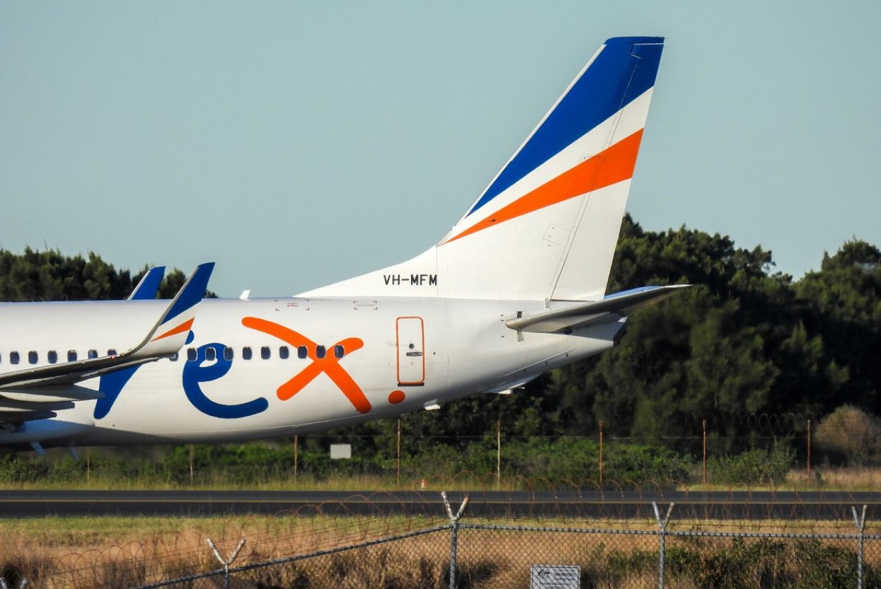 Rex airplane sitting on tarmac ready for take off